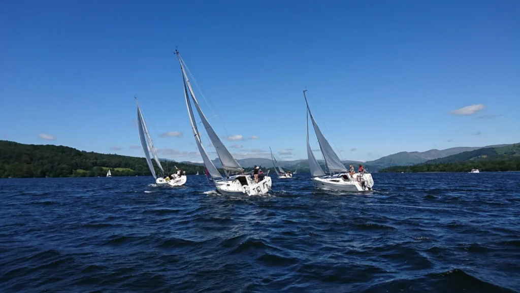 three sails boats sailing